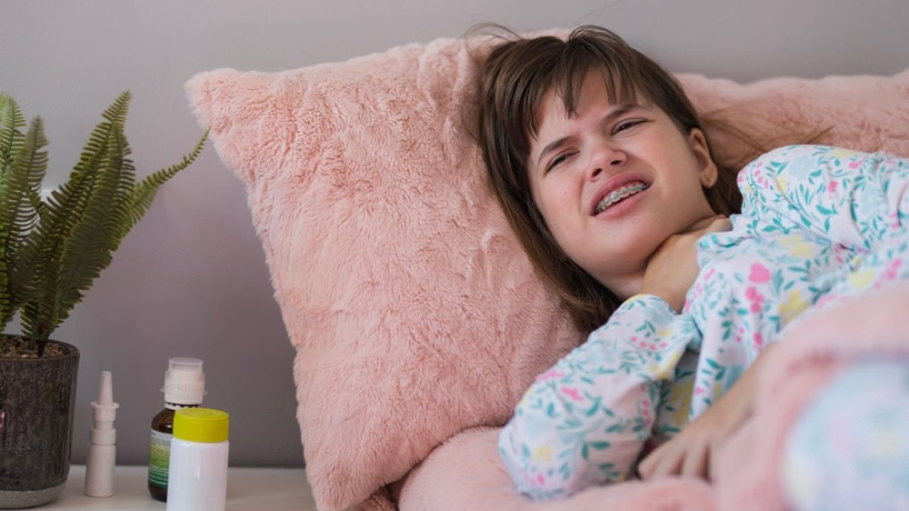 a girl with orthodontic braces suffering from thyroid disease